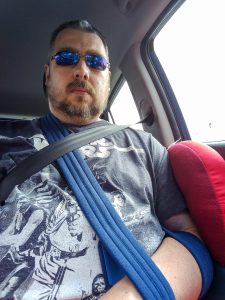 My lovely sling, and a padded neck rest keeping my arm off the door - during the drive back from Cumbria.